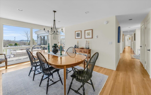 dining room with recessed lighting, a notable chandelier, and light wood finished floors