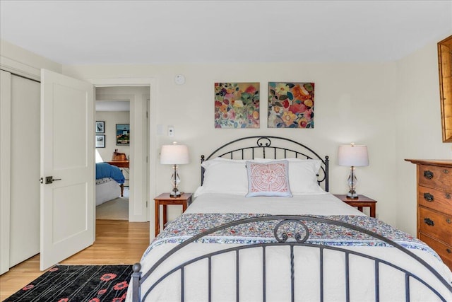 bedroom with a closet and light wood-style flooring