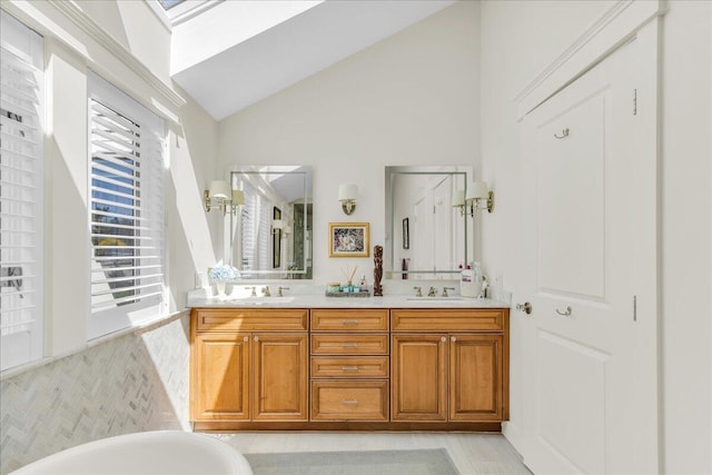 bathroom with double vanity, a sink, lofted ceiling, and a soaking tub