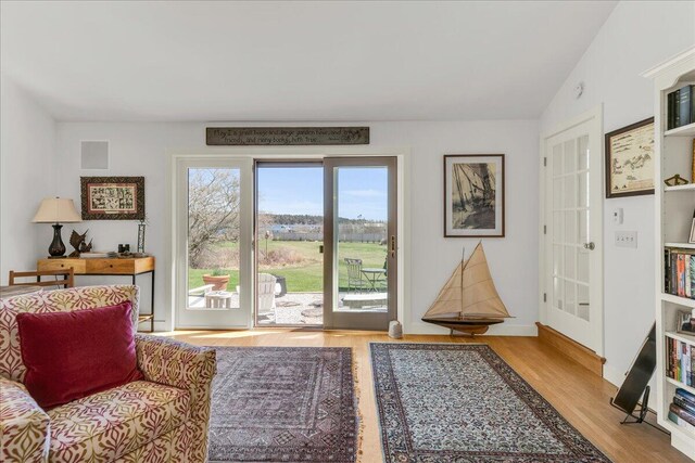 sitting room with visible vents and wood finished floors