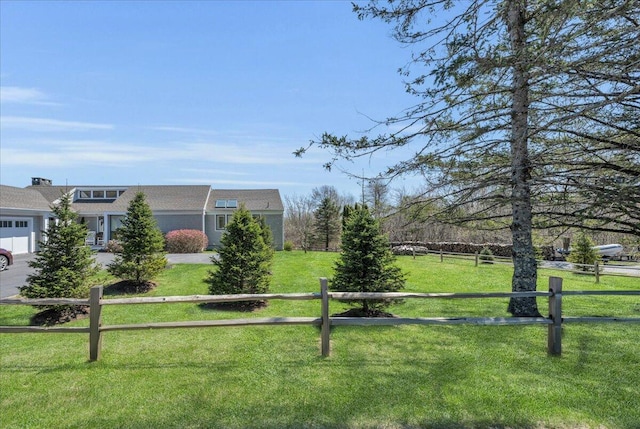 exterior space with a garage, fence, and a front yard