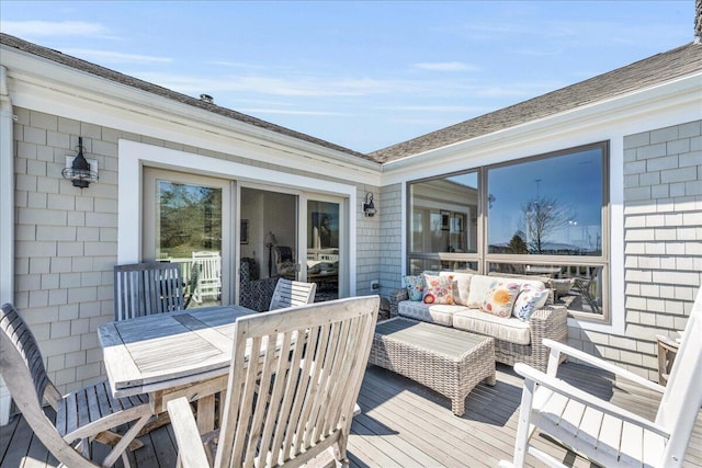 wooden terrace featuring outdoor lounge area and outdoor dining space