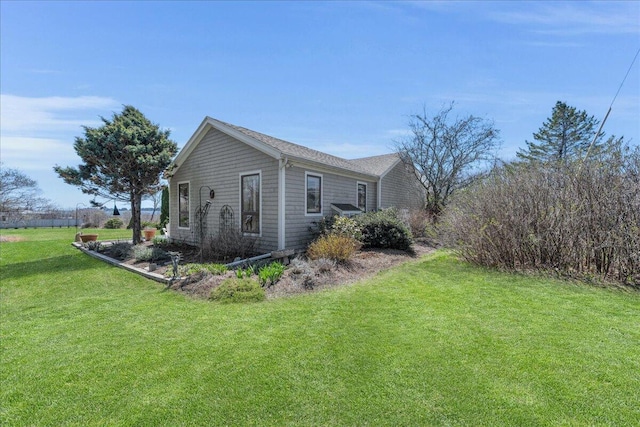 view of side of property featuring a yard