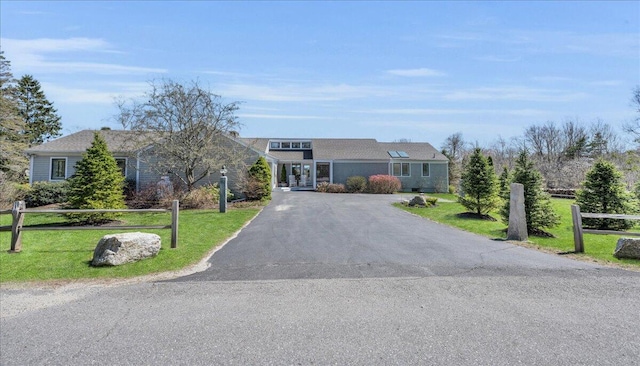 view of front of property with a front yard and aphalt driveway