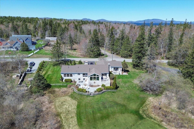 aerial view with a mountain view and a wooded view