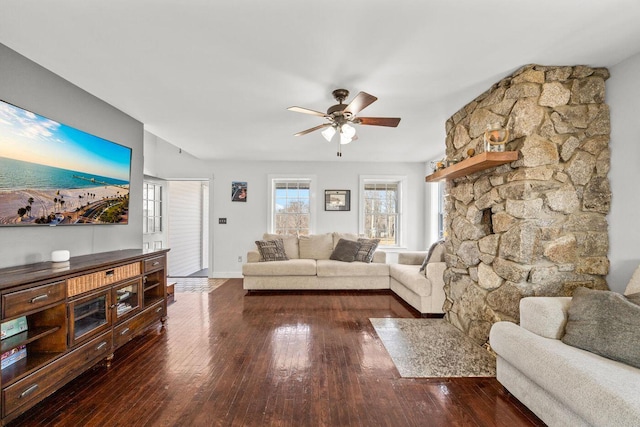 living area with a ceiling fan, baseboards, and hardwood / wood-style flooring