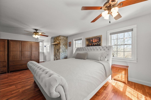 bedroom with baseboards, ceiling fan, and wood finished floors