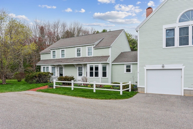 10 Ephraim Tyler Way Unit 10, Kennebunk, ME 04043 - view of front of house featuring a garage, a front yard, a shingled roof, a chimney, and driveway