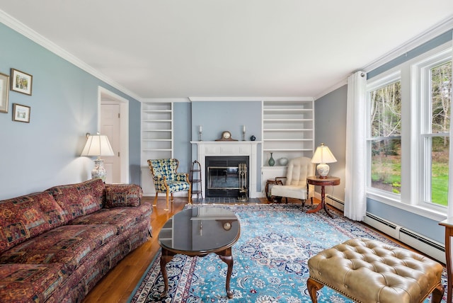 10 Ephraim Tyler Way Unit 10, Kennebunk, ME 04043 - living area with built in shelves, wood finished floors, a fireplace with flush hearth, and crown molding