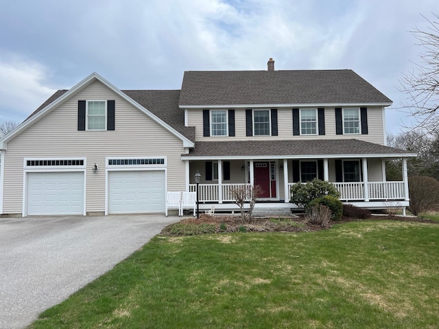 view of front facade with covered porch, a chimney, a front yard, aphalt driveway, and a shingled roof