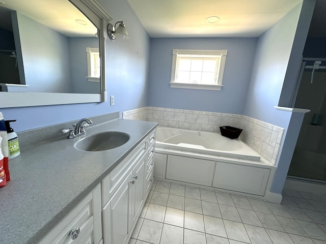 bathroom featuring vanity, a garden tub, and marble finish floor