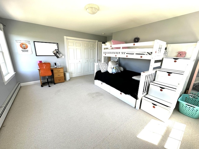 carpeted bedroom featuring a closet, a baseboard radiator, and baseboards