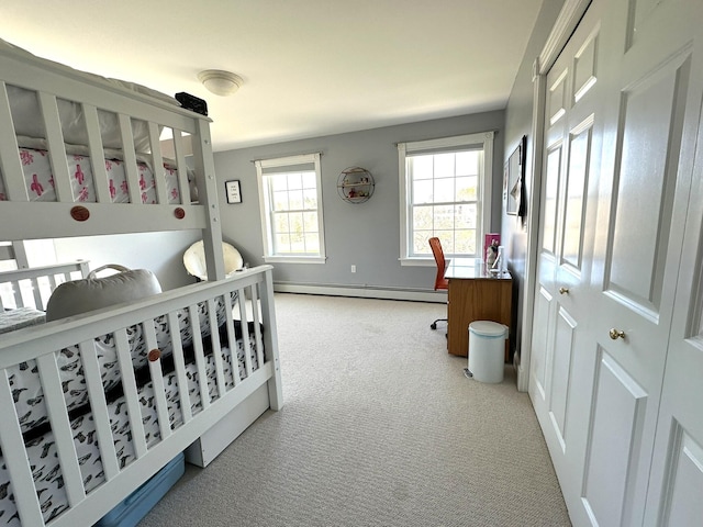 carpeted bedroom featuring baseboard heating