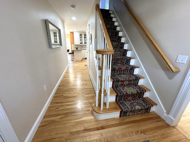 stairs featuring baseboards, recessed lighting, and wood finished floors