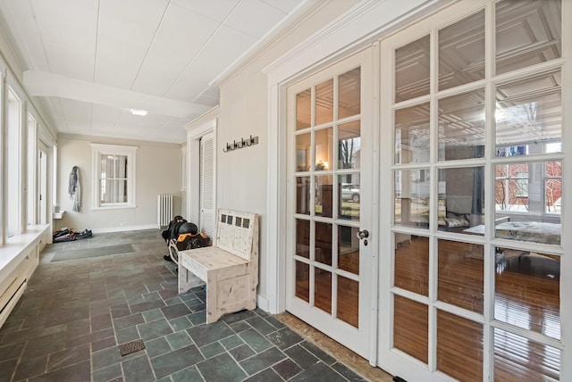 unfurnished sunroom with radiator and french doors