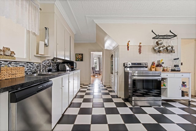kitchen featuring a sink, white cabinets, dark floors, and stainless steel appliances