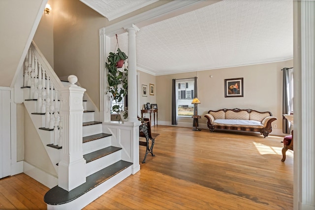 staircase featuring hardwood / wood-style floors and ornamental molding