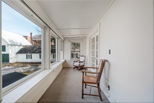 sunroom with french doors and carpet flooring