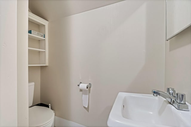 bathroom with toilet and a sink