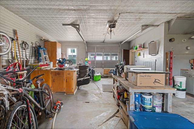 garage featuring a garage door opener and a workshop area