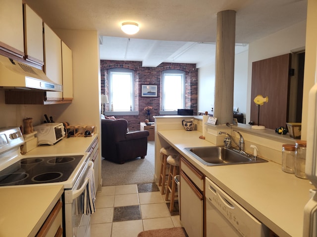 kitchen with light carpet, white appliances, light countertops, under cabinet range hood, and a sink