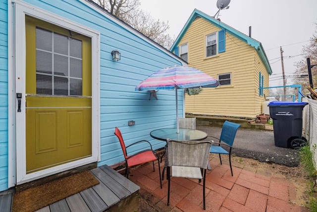 view of patio with outdoor dining space and entry steps