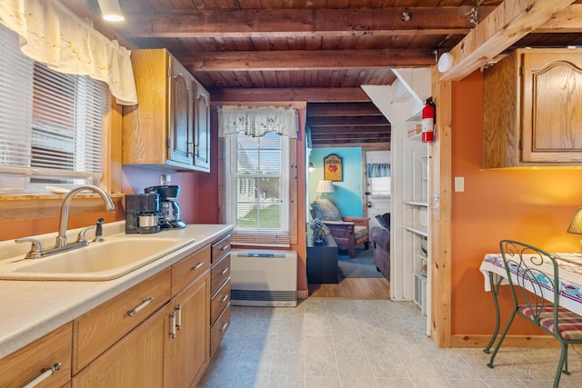 kitchen with a sink, wood ceiling, beamed ceiling, light countertops, and cooling unit
