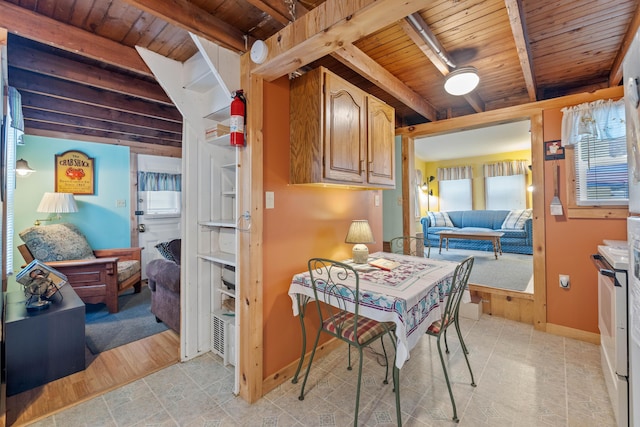 dining room with wooden ceiling, beamed ceiling, baseboards, and light tile patterned floors