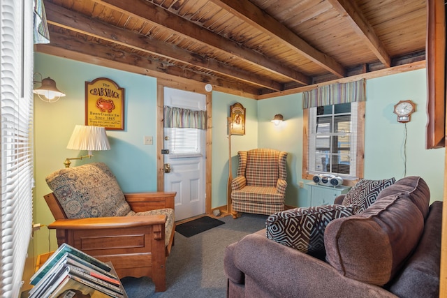 living area with carpet floors, beamed ceiling, and wooden ceiling
