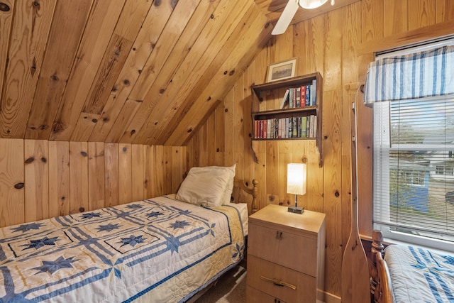 bedroom with lofted ceiling and wooden walls