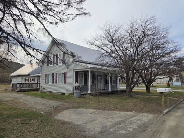 view of home's exterior with a porch and a lawn