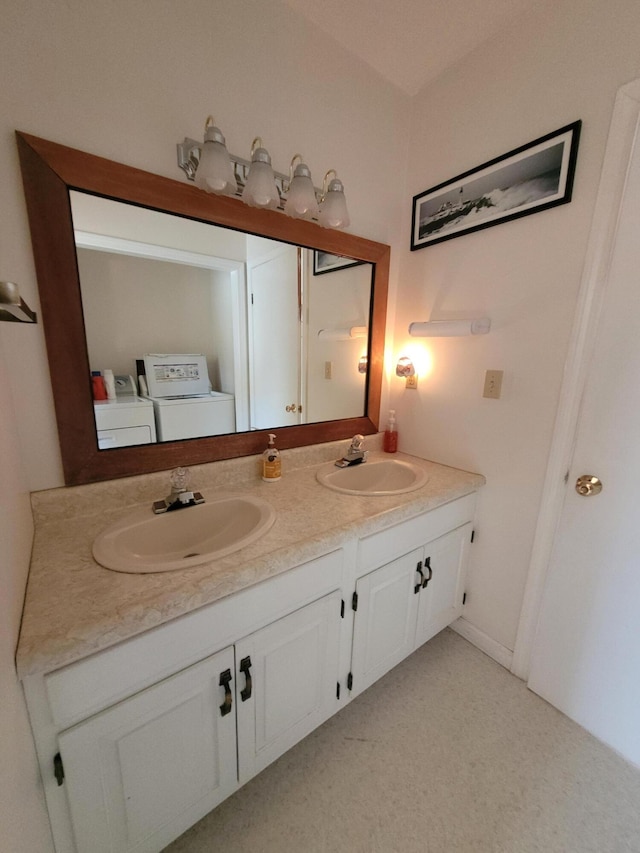 full bath with separate washer and dryer and double vanity
