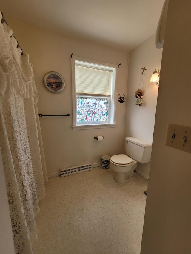 full bath featuring toilet and baseboards