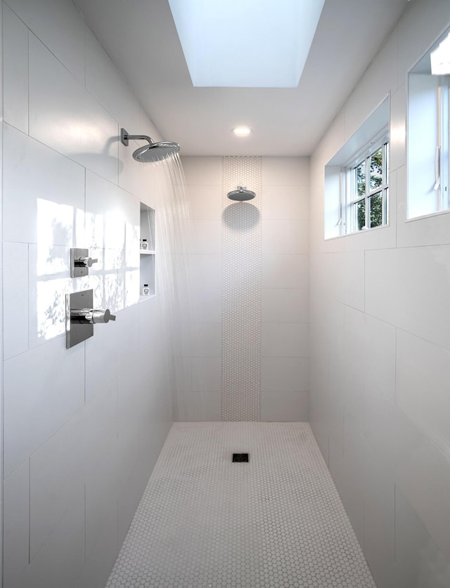 bathroom with a tile shower and recessed lighting
