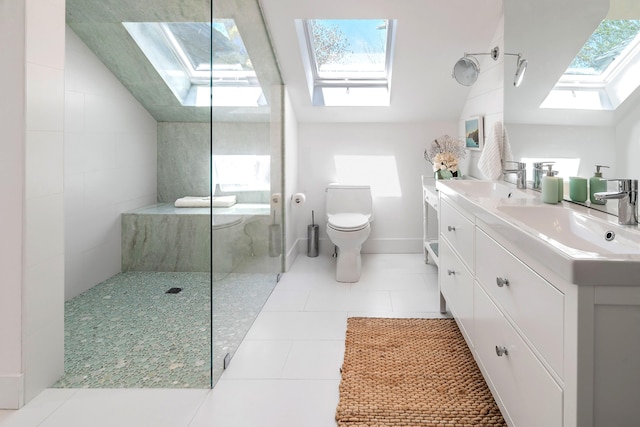 bathroom featuring a walk in shower, toilet, vaulted ceiling with skylight, and a sink
