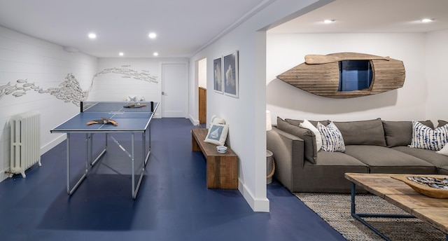 recreation room featuring baseboards, recessed lighting, and radiator