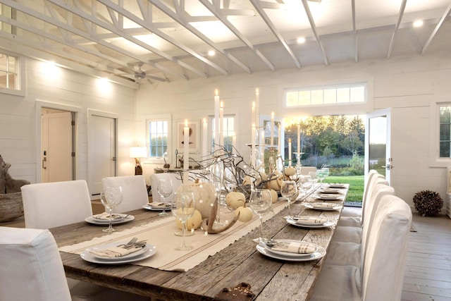 dining space with wood finished floors, a ceiling fan, and plenty of natural light