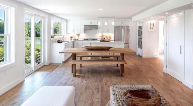 dining area with baseboards, recessed lighting, and light wood-style floors