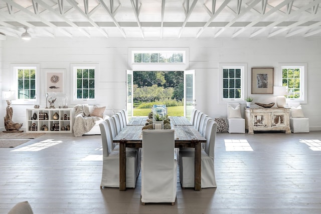 sunroom / solarium with beamed ceiling, a healthy amount of sunlight, and coffered ceiling