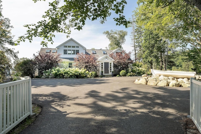 view of road featuring a gated entry and aphalt driveway