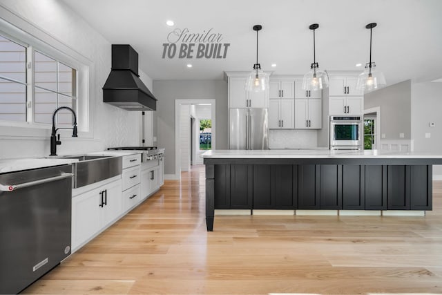 4-16 Tatnic Rd, Wells, ME 04090 - kitchen featuring a sink, stainless steel appliances, light countertops, custom exhaust hood, and recessed lighting