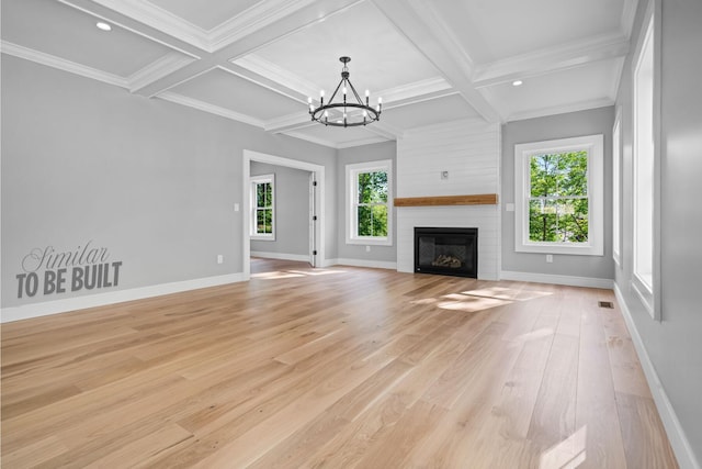 4-16 Tatnic Rd, Wells, ME 04090 - unfurnished living room featuring coffered ceiling, a notable chandelier, baseboards, beamed ceiling, and a large fireplace