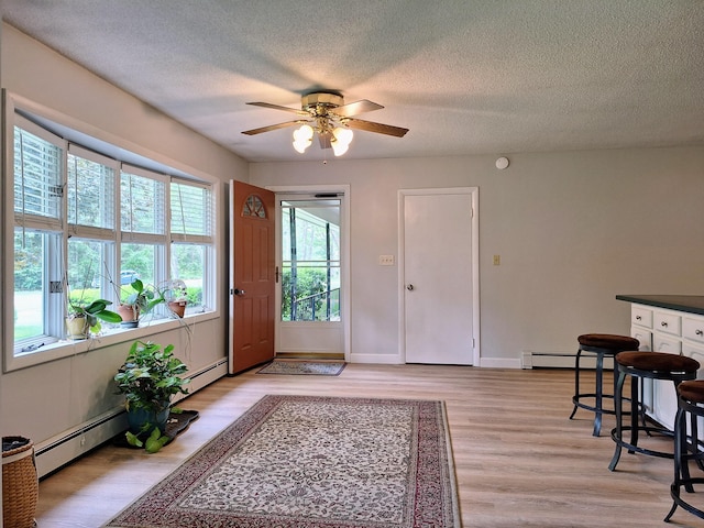 31 Arbor Ave, Topsham, ME 04086 - entrance foyer featuring a baseboard heating unit, a ceiling fan, a textured ceiling, and light wood finished floors