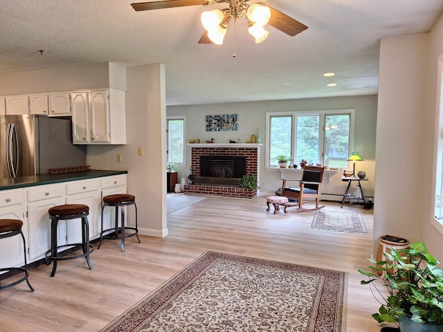 31 Arbor Ave, Topsham, ME 04086 - living area with light wood finished floors, ceiling fan, a brick fireplace, and recessed lighting