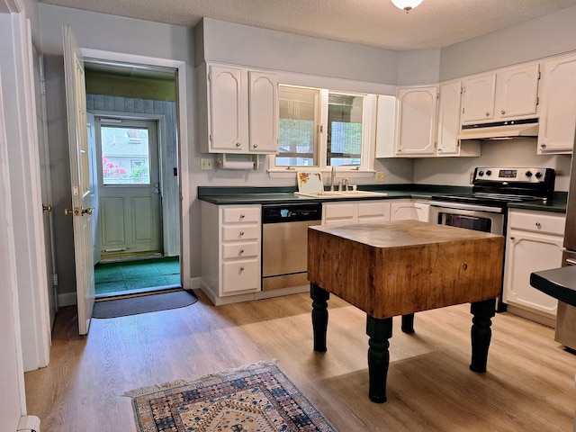 31 Arbor Ave, Topsham, ME 04086 - kitchen with appliances with stainless steel finishes, under cabinet range hood, white cabinets, light wood-style floors, and a textured ceiling