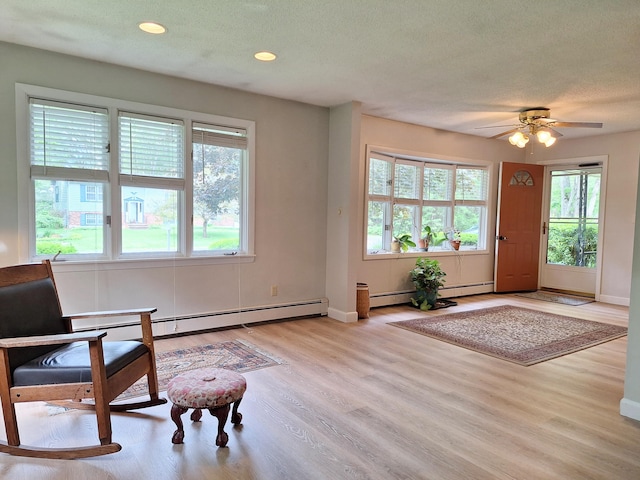 31 Arbor Ave, Topsham, ME 04086 - foyer with wood finished floors, a baseboard radiator, a ceiling fan, recessed lighting, and a textured ceiling