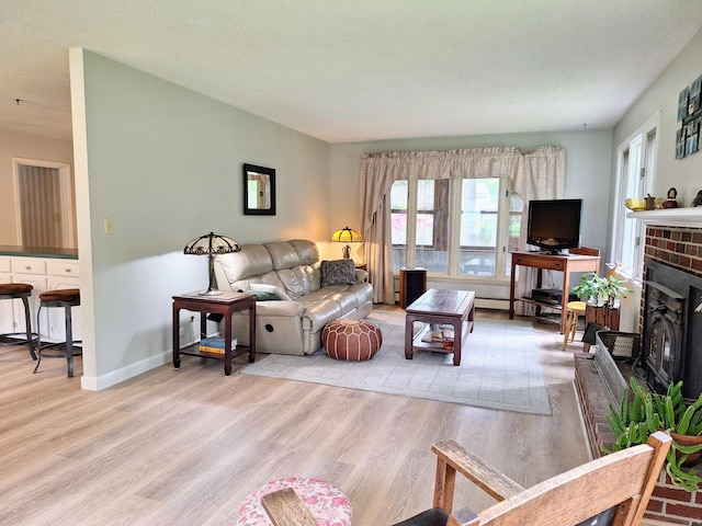 31 Arbor Ave, Topsham, ME 04086 - living room with light wood-type flooring and a brick fireplace