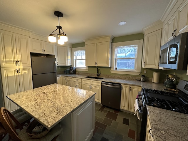 14 Elm St, Houlton, ME 04730 - kitchen with light stone counters, pendant lighting, a breakfast bar area, a sink, and appliances with stainless steel finishes