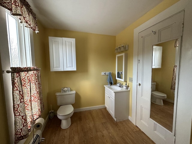 14 Elm St, Houlton, ME 04730 - bathroom featuring baseboards, wood finished floors, toilet, and vanity