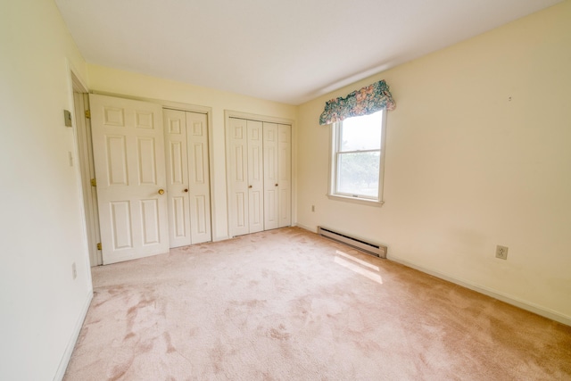 6 Seaside Dr, Belfast, ME 04915 - unfurnished bedroom featuring a baseboard radiator, two closets, and carpet flooring